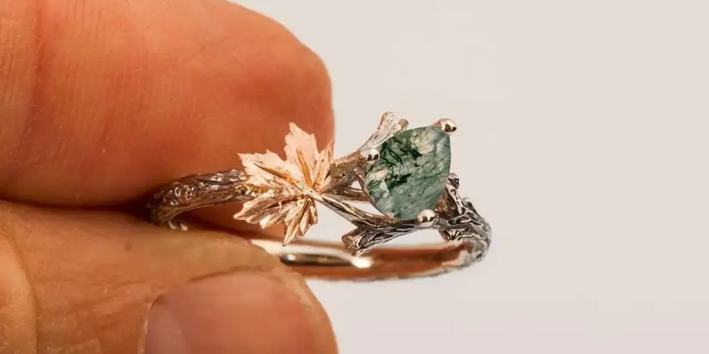 the man holding the moss agate ring