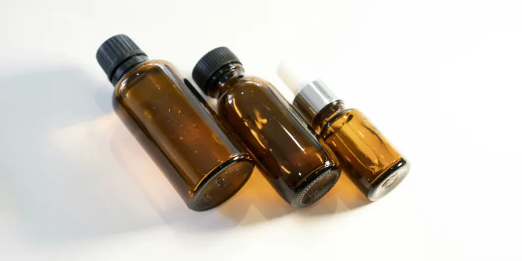 three bottles of essential oils on a white surface