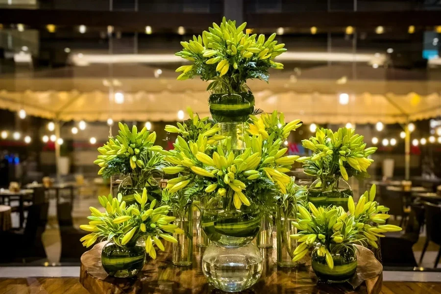 transparent glass vases arranged using lush green leaves