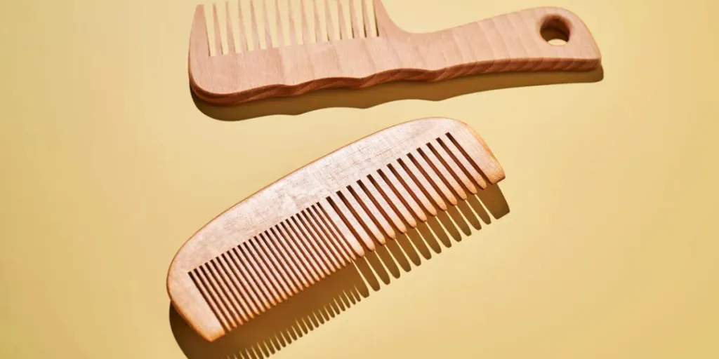 two wooden combs on a yellow background