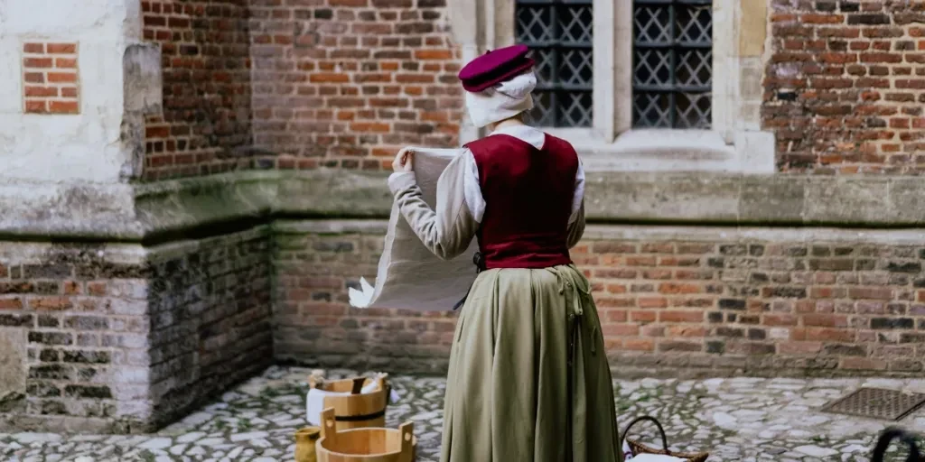 woman doing laundry outside with brown buckets