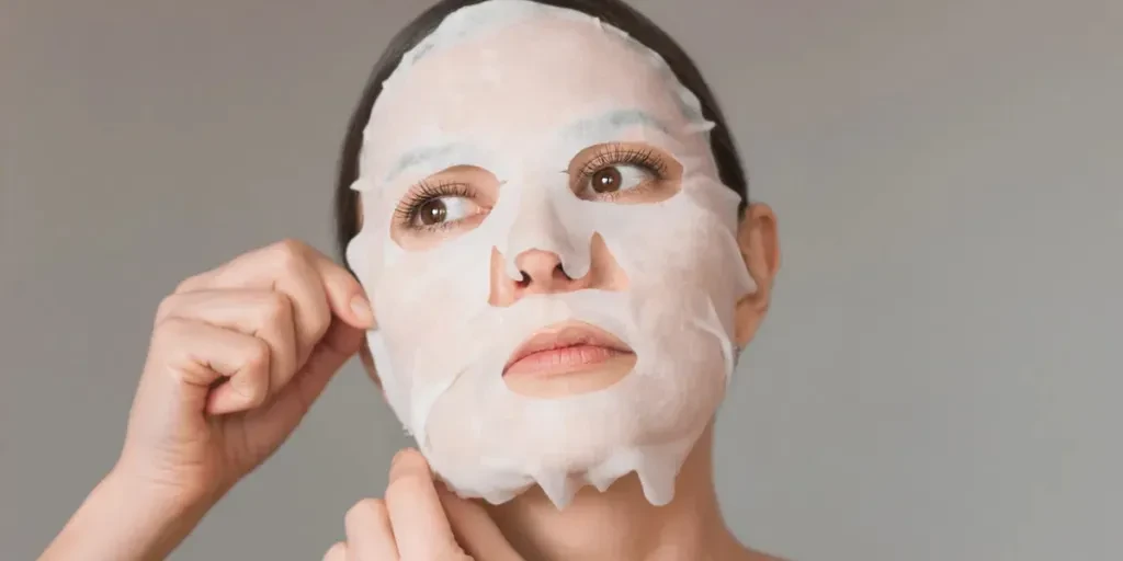 young Caucasian brunette woman uses a white fabric moisturizing