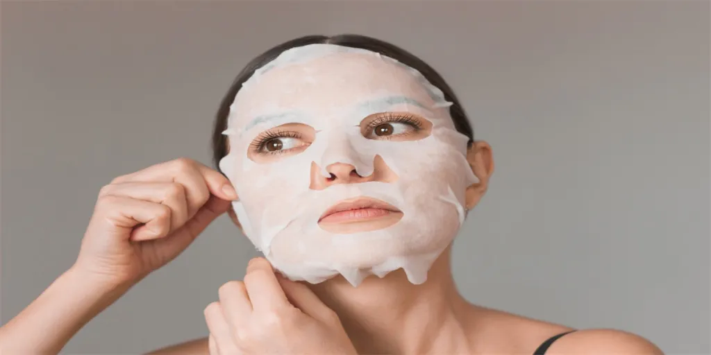 young Caucasian brunette woman uses a white fabric moisturizing