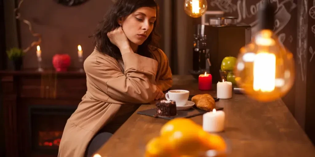 young brunette woman sitting at the bar