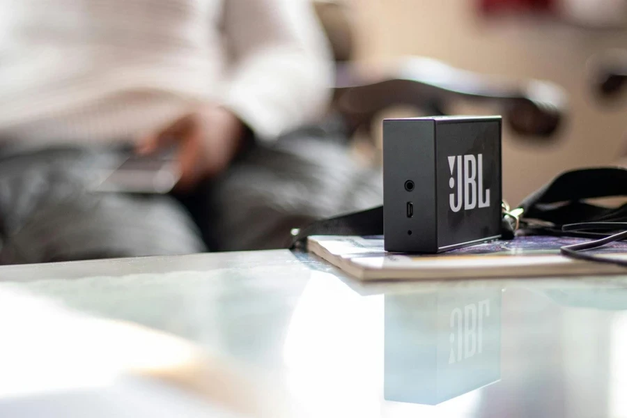 A JBL mini Bluetooth speaker on the table