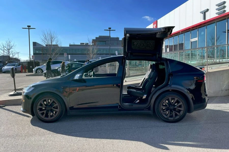 A black Tesla Model X with back doors open