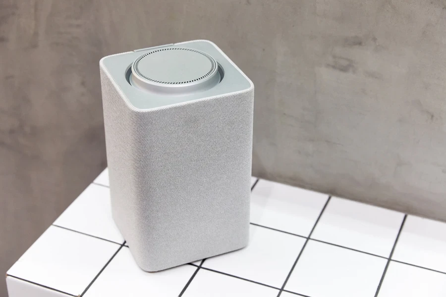 A gray Bluetooth shower speaker in a bathroom