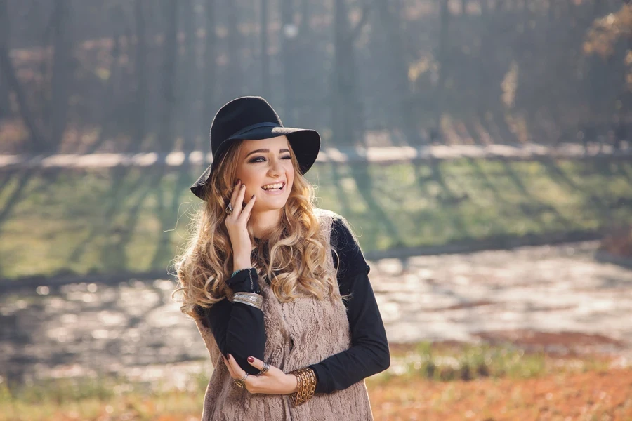 A hippie lady wearing a beige quilted corduroy vest