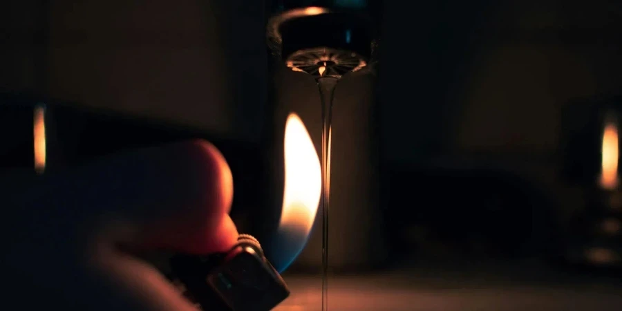 A person holding a lighter in front of a sink