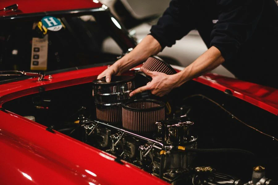 A person putting air filters in a car