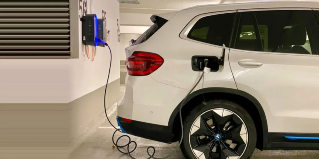 A white electric car at a charging station