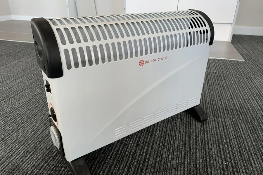 A white, metallic, portable electric heater