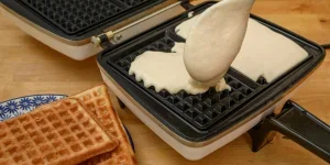 Batter being added to a waffle maker