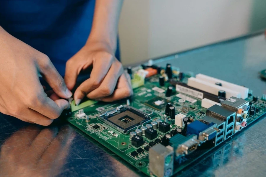 Close-up Photo of Person working on a Motherboard