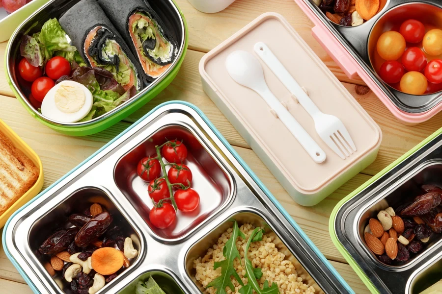 Containers with healthy food on wooden background top view