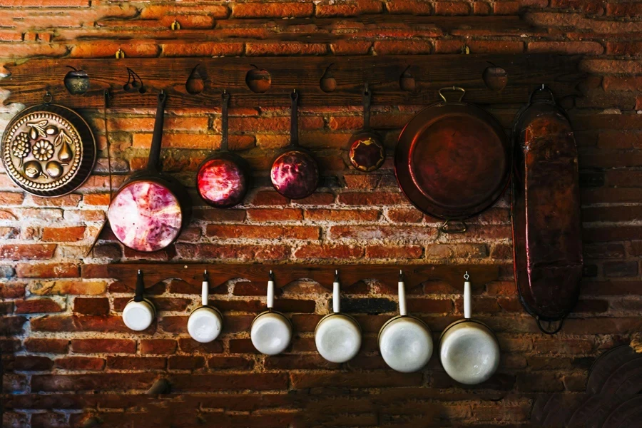 Cookware set hanging on brick wall