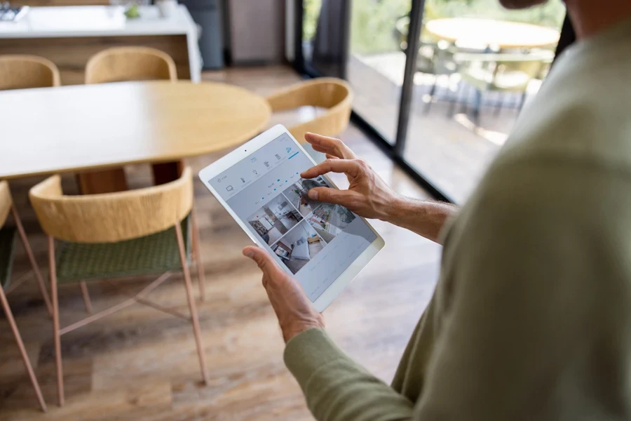 Man monitoring his home with an AI security camera