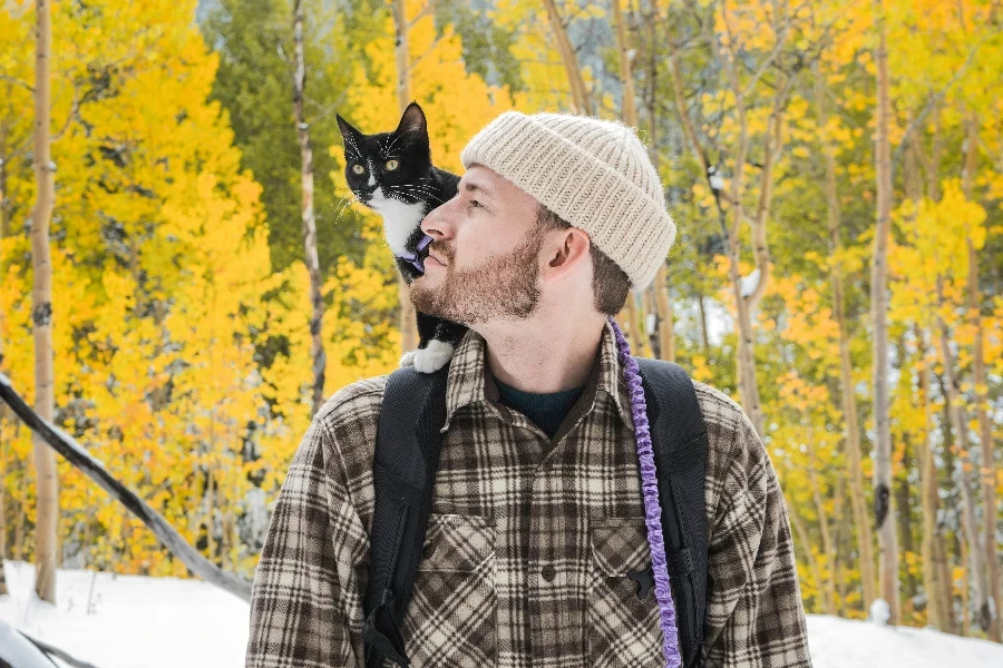 Owner with his cat in the woods