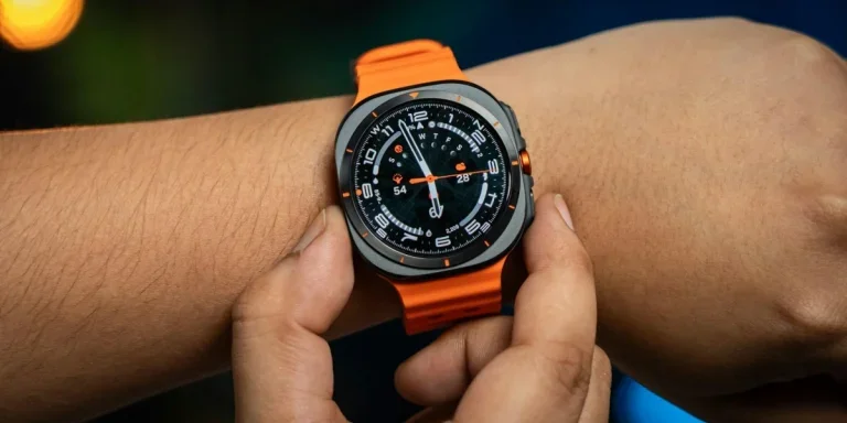 Samsung watch on a wrist with orange strap