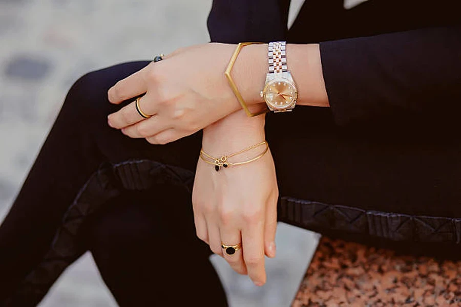 Solid gold bracelet with a silver watch and rings