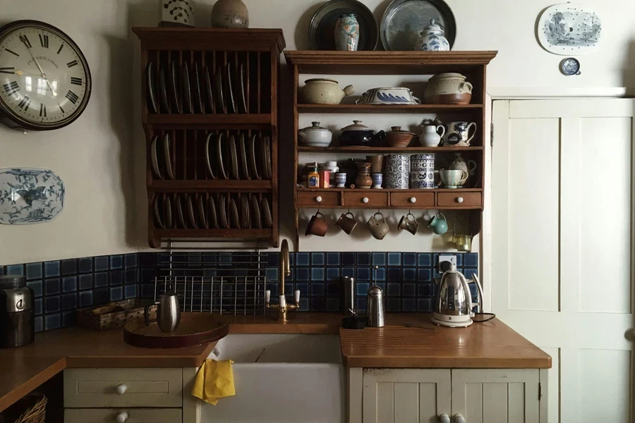 White kitchen with ceramic dinnerware and brown cupboards