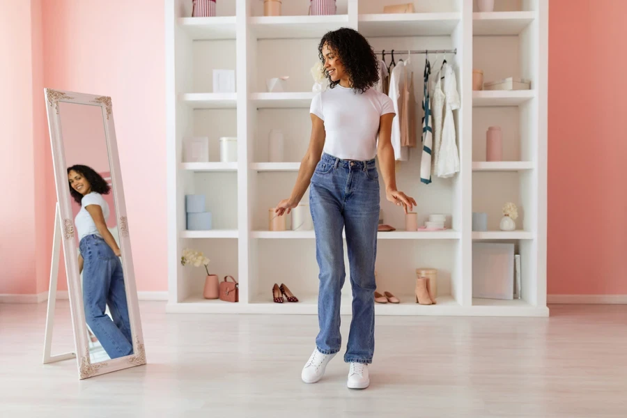 Woman checking herself out in high-rise straight-leg jeans