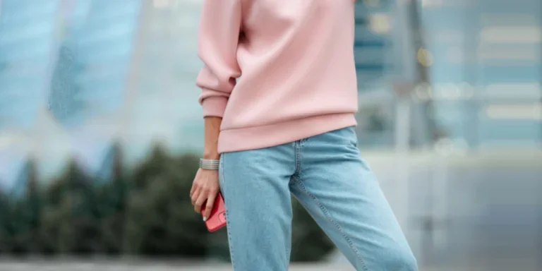 Woman in a pink sweat-shirt and straight-leg jeans