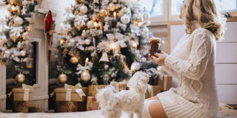 Woman sitting in a white sweater dress