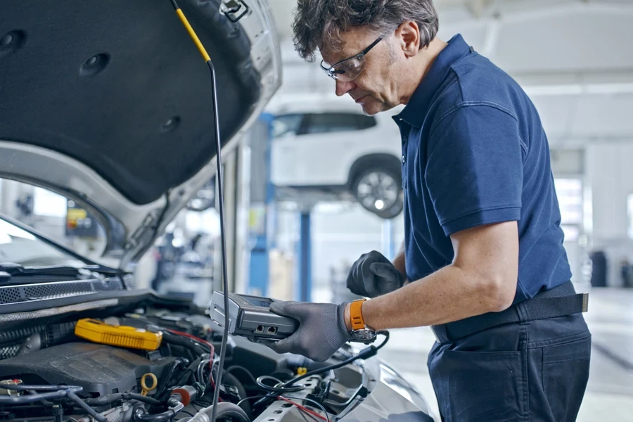 mechanic inspecting a car in a shop