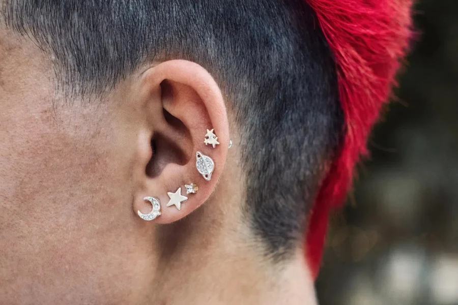 Woman with a red dyed mohawk and silver ear piercings