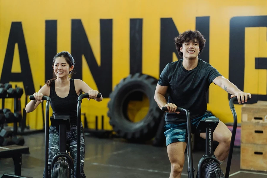 A Couple Using Elliptical Trainers