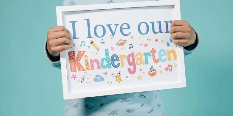 A child holding a painting on a white canvas