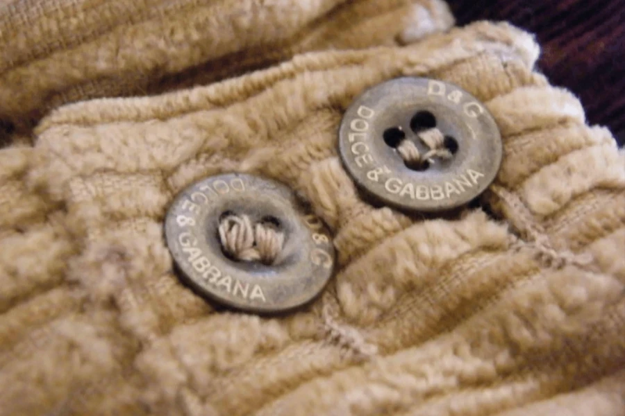 A close shot of buttons on a corduroy fabric