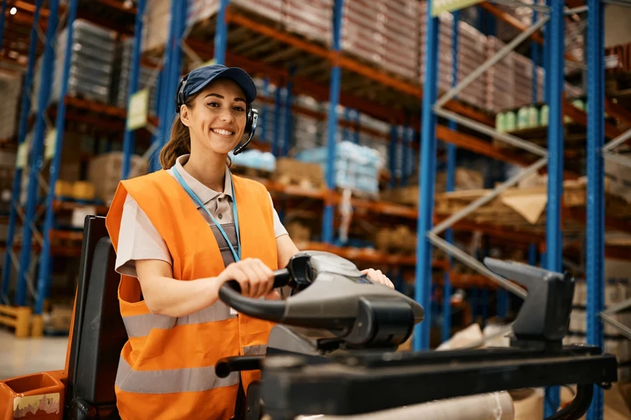 A female riding a pallet truck