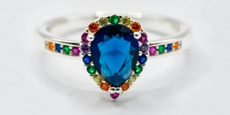 A ring with blue stone surrounded by multicolored stones