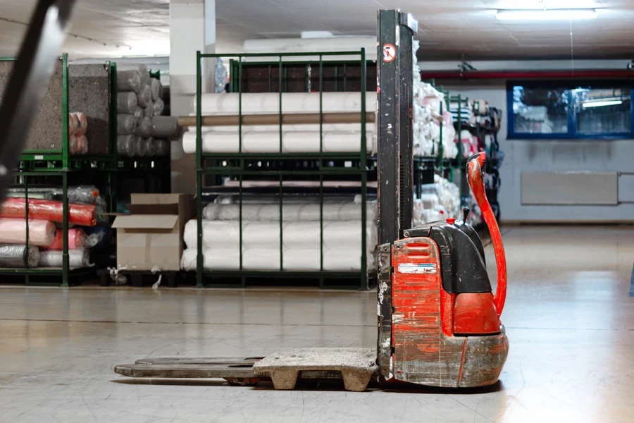 An old, used electric stacker in a small factory