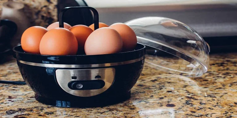 Black color egg cooker with soft-boiled eggs inside machine
