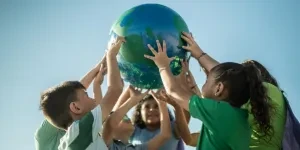 Children holding a planet outdoors