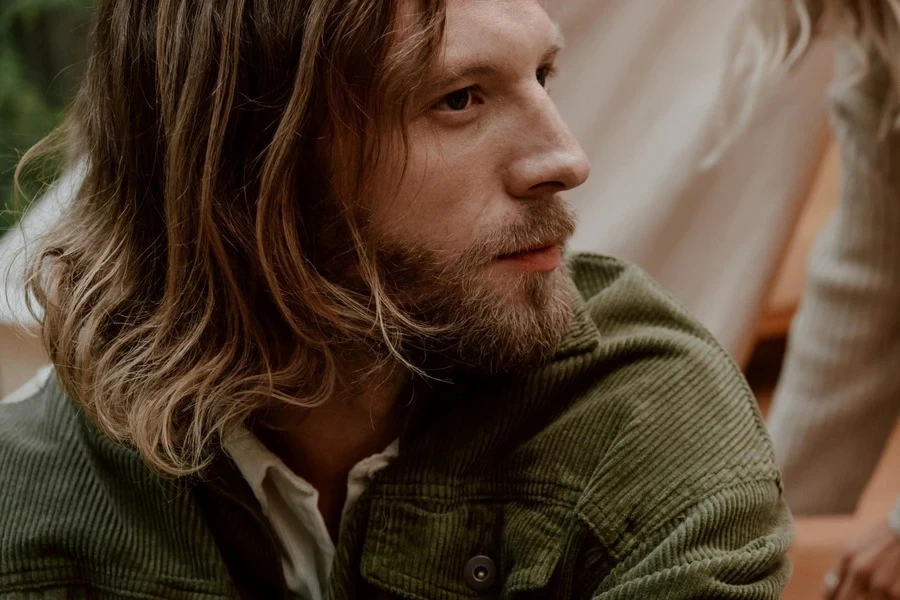 Close-up of a man wearing green corduroy blazer