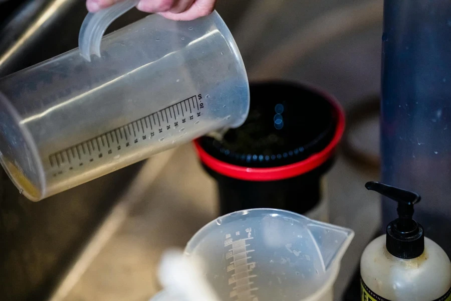 Close-up of a measuring cup being used to pour liquids in a kitchen environment