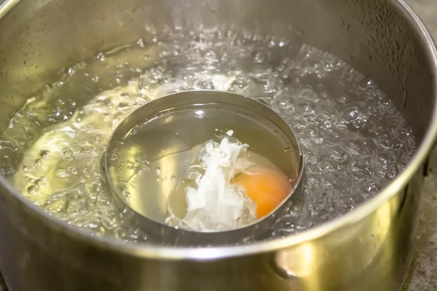 Egg cooking in boiling water