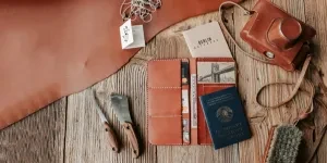 Leather Card Holder and Leather Crafting Tools Lying on a Wooden Surface