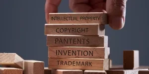 Man adding blocks showing copyright and trademark