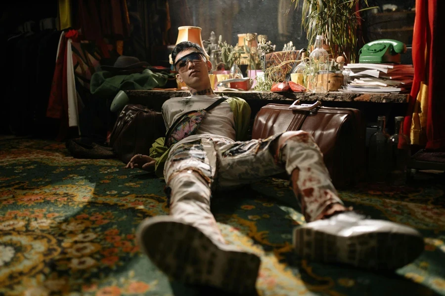 Man in Green and Brown Camouflage Pants Sitting on Green and Brown Floral Area Rug