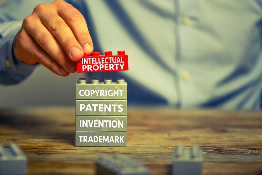 Man placing intellectual property blocks