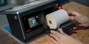 Person Changing the Roll of Thermal Paper