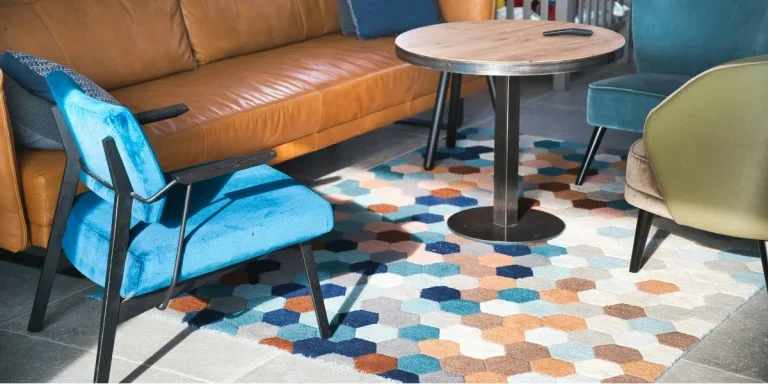 Picture of a living room with sofa, armchairs and rug