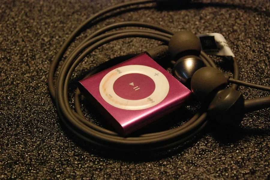 Pink MP3 Player with Earphones on Textured Surface