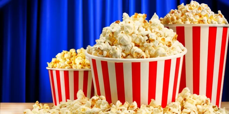 Popcorn in red and white striped paper buckets at the cinema