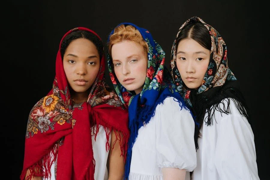 Three women standing together and wearing Babushka headscarves